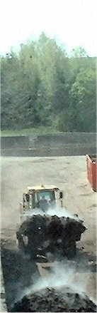 Manure being moved by machine. Manure being moved by machine.