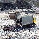 Refuse vehicle discharges waste during landfilling